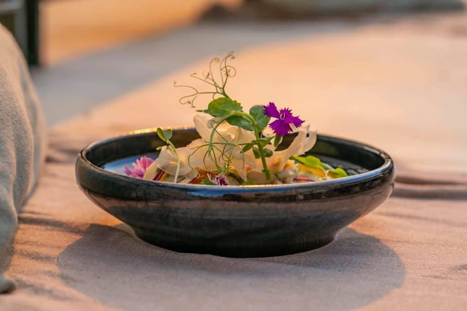 Ceviche served on the sand at sunset